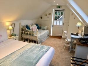 a bedroom with a bed and a desk at House of Agnes in Canterbury