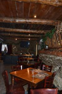 a dining room with a wooden table and chairs at Casa Nova Regi in Soldeu