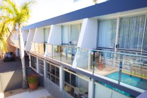 a balcony of a building with a swimming pool at Brunswick River Inn in Brunswick Heads