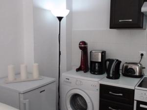 a kitchen with a washing machine and a lamp at Marine House Andrianna -Adults only in Siviri