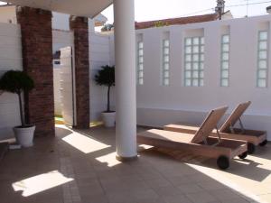 a pair of chairs sitting on a patio at Marine House Andrianna -Adults only in Siviri