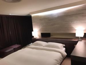 Letto o letti in una camera di JBG Hotspring Resort Hotel