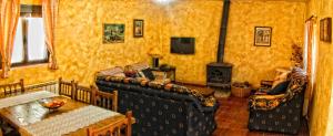 a living room with a couch and a fireplace at Los Sotillos De Gredos in Arenas de San Pedro