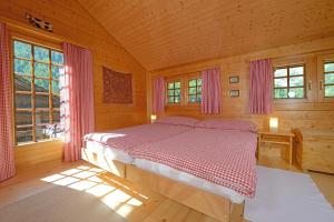a bedroom with a bed in a wooden cabin at Chalet Tuk-Tuk in Zermatt