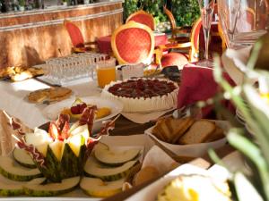 a table with many different types of food on it at Hotel Begoña Park in Gijón