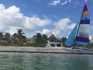 a sailboat on the water in front of a beach at Jose´s Ha Uay House in Progreso