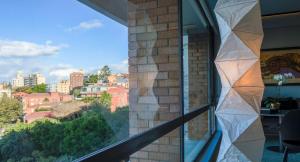 a window with a view of a city at The KC Elizabeth Bay in Sydney +6 photos