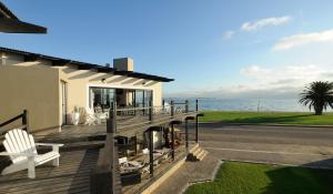 a house with a deck with a view of the ocean at Oyster Box Guesthouse in Walvis Bay