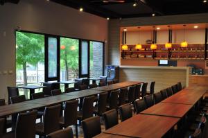 a row of tables and chairs in a restaurant at One City One Vacation Farm in Nantou City