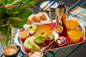 a tray of breakfast foods and drinks on a table at Almyra Waterfront Accommodation in Tasman