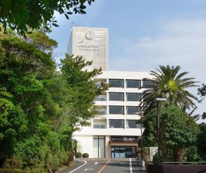 a building with a clock tower on top of it at Toba International Hotel in Toba