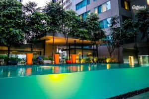 a swimming pool in front of a building at Resort Hostel In City in Kuala Lumpur