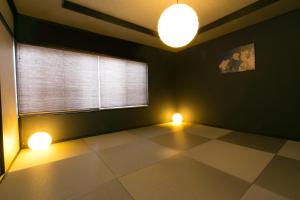 a living room with two lights and a window at Hosta Nijo Aoi in Kyoto