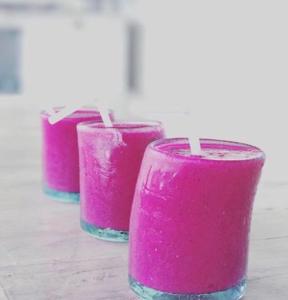 a row of three pink glasses sitting on a table at Gravity Eco Boutique Hotel - Adults Only in Uluwatu