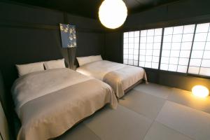 Giường trong phòng chung tại Hosta Nijo Aoi