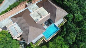 an overhead view of a house with a swimming pool at Korsiri Pool Villas in Panwa Beach