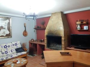 a living room with a couch and a fireplace at Quevoy in Alcañiz