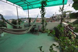a hammock on the roof of a house at Metro Eco Hotel in Kathmandu
