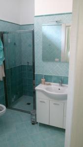 a bathroom with a sink and a shower at Acquamarina Accommodation in Massa Lubrense