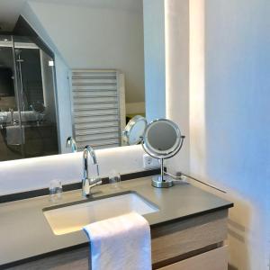 a bathroom with a sink and a mirror at Kleiner Ulenhof in Wenningstedt +44 photos