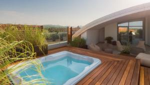 a hot tub on the deck of a house at Savhotel in Bologna