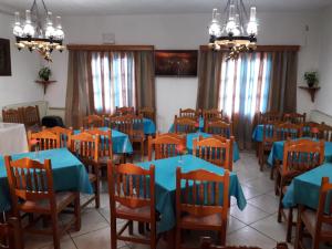 a dining room with blue tables and chairs at Effie Hotel in Skala