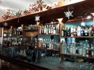 a bar filled with lots of bottles of alcohol at Effie Hotel in Skala