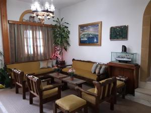 a living room with a couch and a table at Effie Hotel in Skala