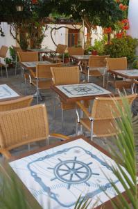 a group of tables and chairs in a patio at Effie Hotel in Skala