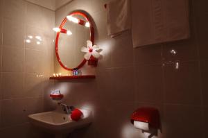 a bathroom with a sink and a mirror at Effie Hotel in Skala