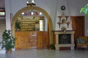 a shop with an archway and a fireplace in a room at Effie Hotel in Skala