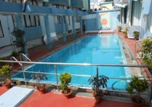 a large swimming pool on top of a building at Hotel Niladri in Puri
