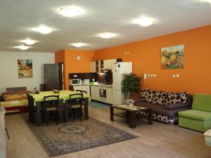 a living room with a couch and a table and a kitchen at Apartmány Mia in Kežmarok