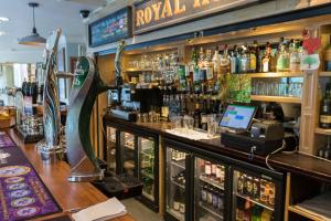 a bar with a counter with a lot of alcohol at Plas y Brenin - National Outdoor Centre in Capel Curig