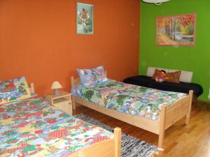 A bed or beds in a room at Viola Vendégház
