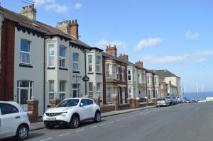 a row of houses on a street next to the ocean at Armada Guesthouse in Redcar