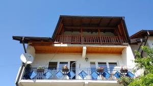 a building with a balcony with flowers on it at "Athos"apartment potkrovlje in Višegrad