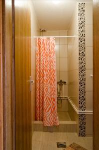 a bathroom with a zebra shower curtain at Apartments Maja in Soko Banja