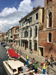 a group of people on a boat in a canal at La Chambre D'Ella in Venice