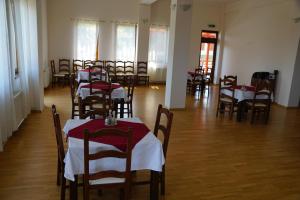 a room with tables and chairs with red and white table cloth at Pensiunea Casa Bunicului in Mociu