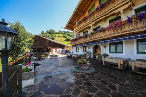 a courtyard of a building with benches and flowers at Alpenhof Grafleiten in Zell am See