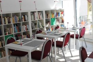 two tables and chairs in a library with bookshelves at Zum Löwen in Bad Homburg vor der Höhe