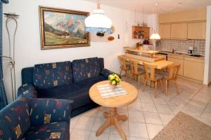 a living room with a couch and a table at Sonnenpark, Ihr Bett im Allgäu in Bad Hindelang