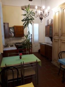 a kitchen with a table and a dining room at Grandpa Mau in Lucca