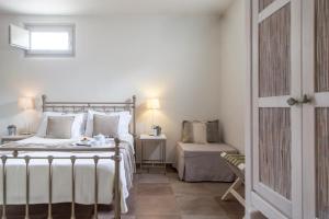 a bedroom with a bed and a table and a chair at Portes Houses in Koufonisia