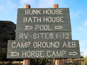 a sign for a bunk house bath house pool and camp groundaq at Terlingua Ranch Lodge in Terlingua