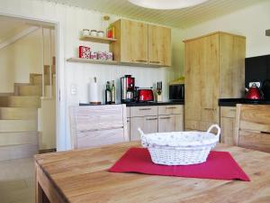 a kitchen with a table with a basket on it at Landhaus Selma in Wieck