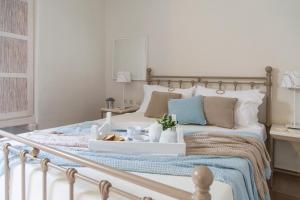 a bedroom with a bed with a tray of food on it at Portes Houses in Koufonisia