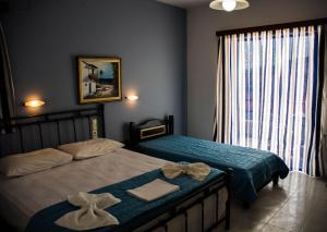 Ένα ή περισσότερα κρεβάτια σε δωμάτιο στο Christina Perlia Studios