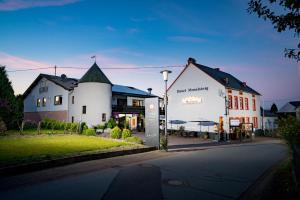 a group of buildings on a city street at Hotel Moselsteig in Osann-Monzel